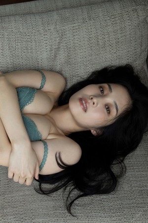 A woman in a blue dress sitting on the floor.