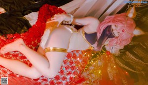 A woman in a bikini sitting on a bed of flowers.