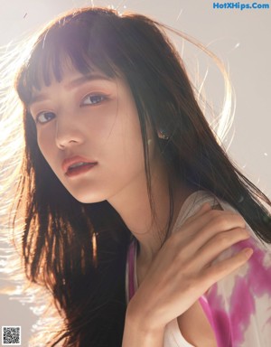 A magazine page with a picture of a woman with long black hair.
