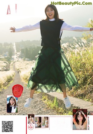 A woman in a school uniform pointing at something.