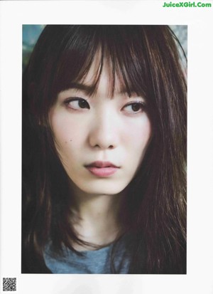 A magazine page with a picture of a girl with long hair.