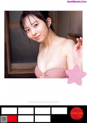 A woman sitting in a bathtub holding a shower head.