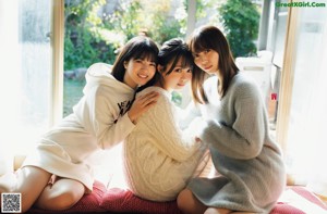 A group of young women standing on top of a grass covered field.