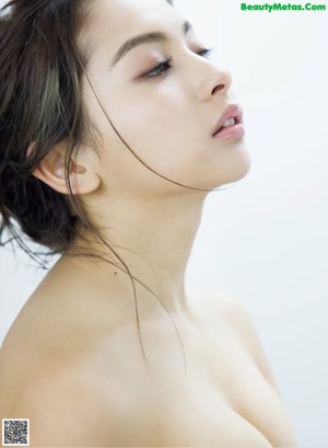 A woman in a white lingerie posing for a picture.