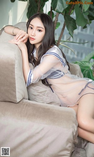 A woman in a blue and white lingerie sitting on a wooden bench.