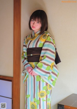A woman in a red kimono is posing for a picture.